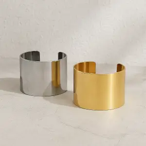 Gold and silver wide cuff bracelets on display