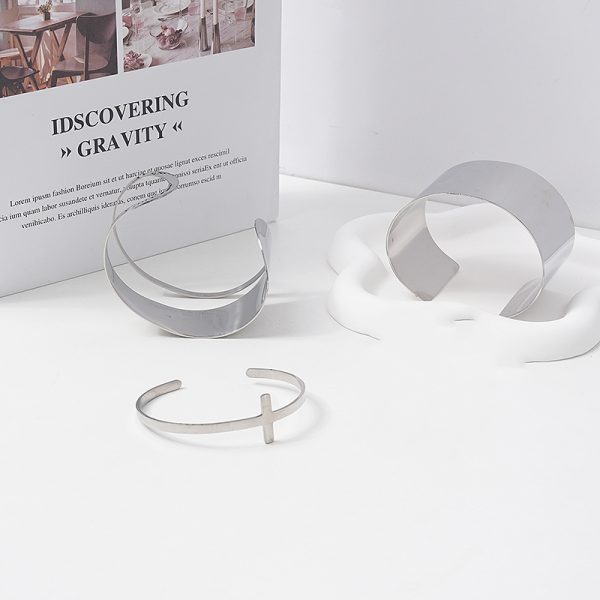 Gold and silver wide cuff bracelets on display