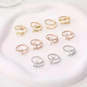 Custom stainless steel name rings in gold, silver, and rose gold with personalized letter designs