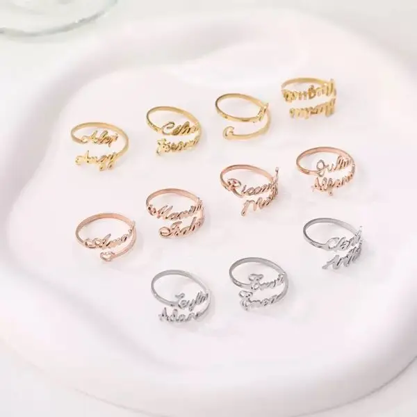 Custom stainless steel name rings in gold, silver, and rose gold with personalized letter designs
